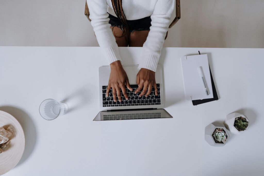 stock photo of a vertical view of a woman typing on a laptop